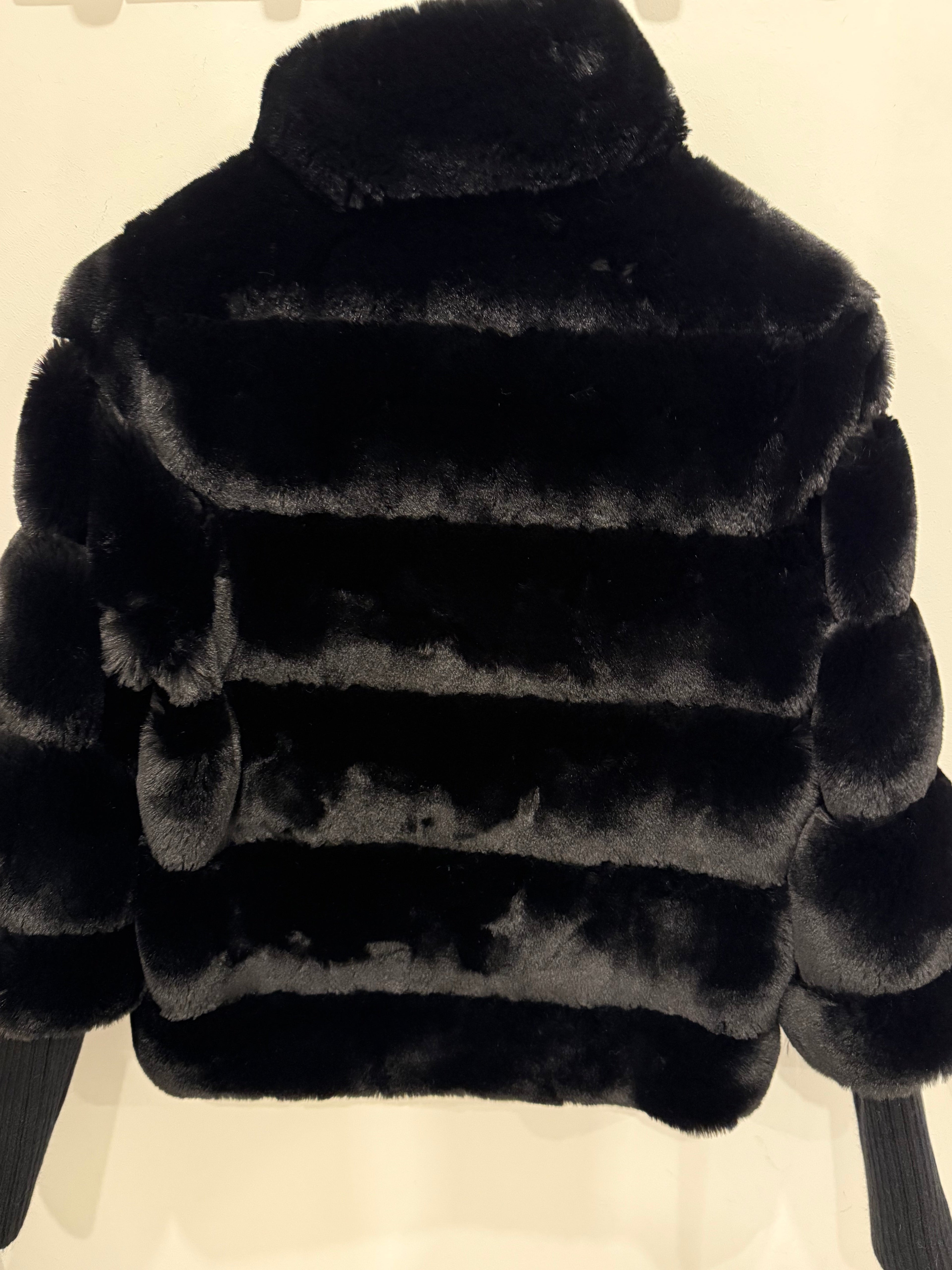 Faux fur jacket with knitted sleeves